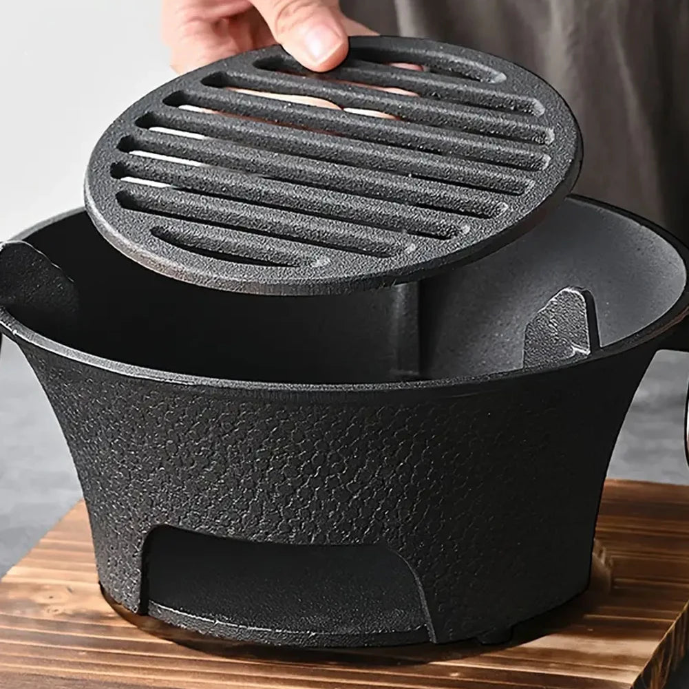 Black cast iron pot with a lid on a wooden surface
