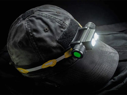 Person wearing a cap with a headlamp attached on a dark background