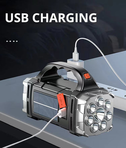 Handheld flashlight with USB cable charging on a dark background