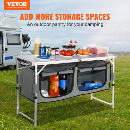Outdoor storage table with compartments and camping items on a grassy field with VEVOR branding.