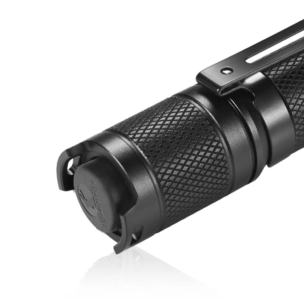 Black tactical flashlight on a white background