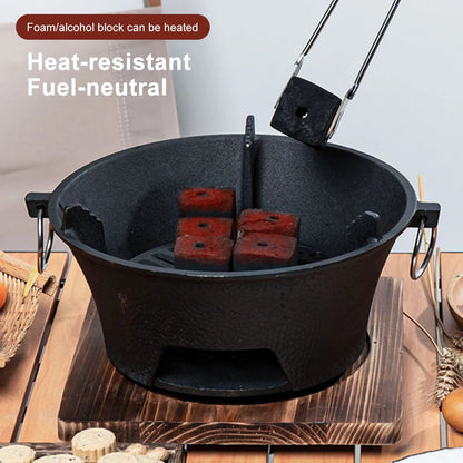 Black heat-resistant container with red foam/alcohol blocks on a wooden surface