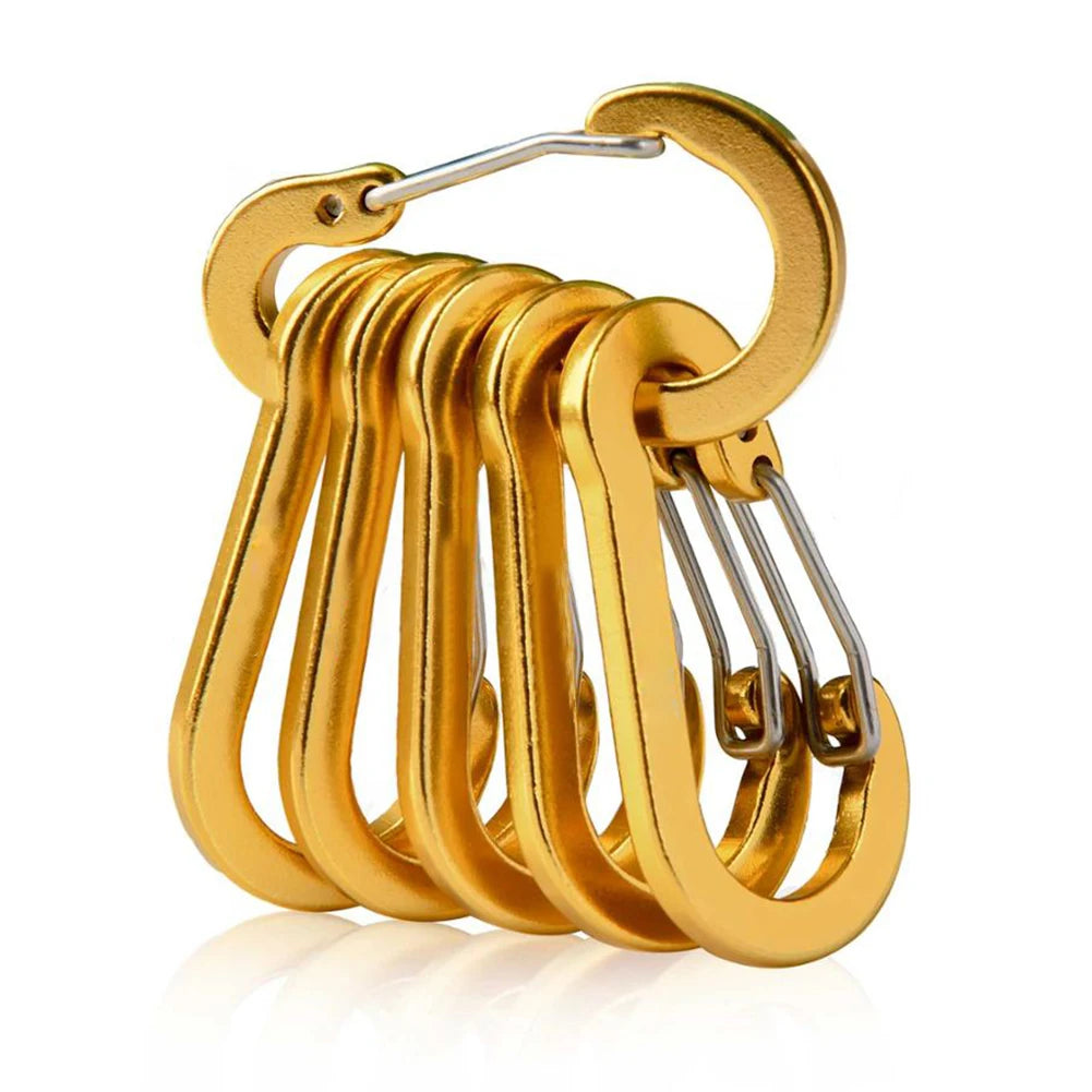 Set of gold carabiners on a white background