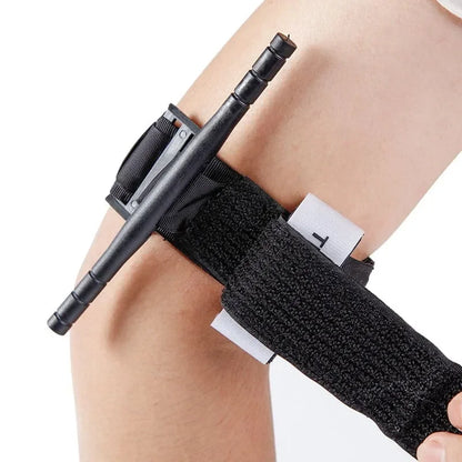 Black knee brace on a person's knee with a white background