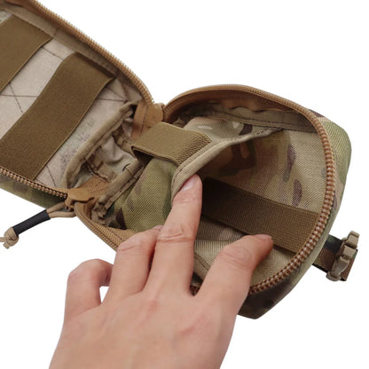 A close-up of a tan tactical pouch with a hand opening it to show interior compartments, zippers, and elastic straps on a white background.