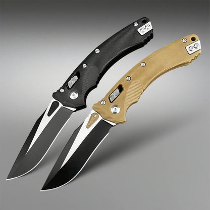 Two folding knives with black and gold handles on a gray background
