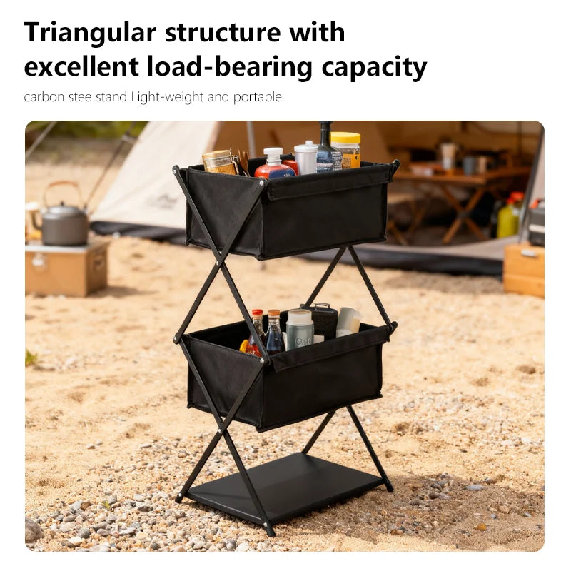 Black triangular structure with items on a camping site