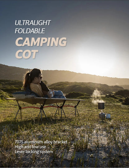 Person sitting on an ultralight foldable camping cot in a scenic outdoor setting.