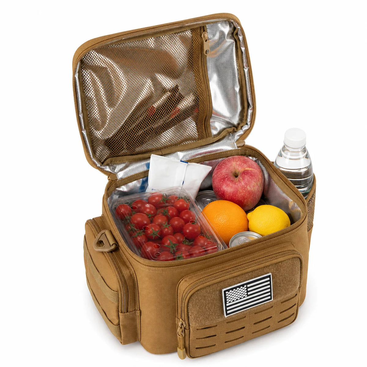 A tan insulated lunch bag shown open on a white background, filled with food items including tomatoes, an apple, an orange, a lemon, a water bottle, and a small can. The bag has a front pocket with a black-and-white American flag patch and a silver reflective interior.