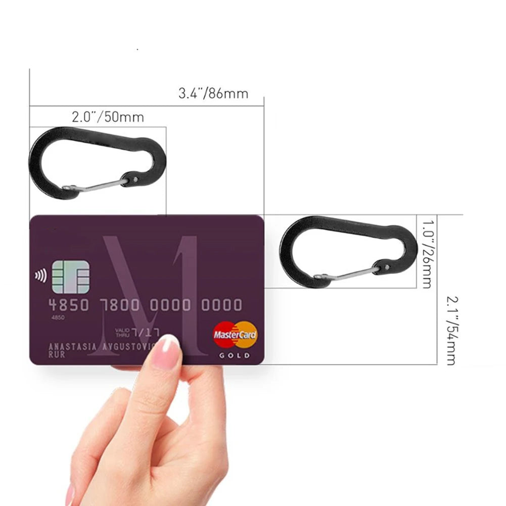 Card with Mastercard logo held by a hand, with measurements of a carabiner and card.
