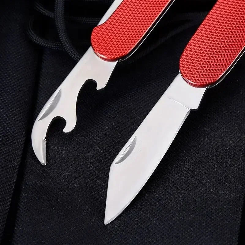 Multitool with red handle and silver tools on a black background