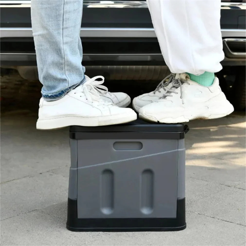Two people using a gray step stool to get into a car.