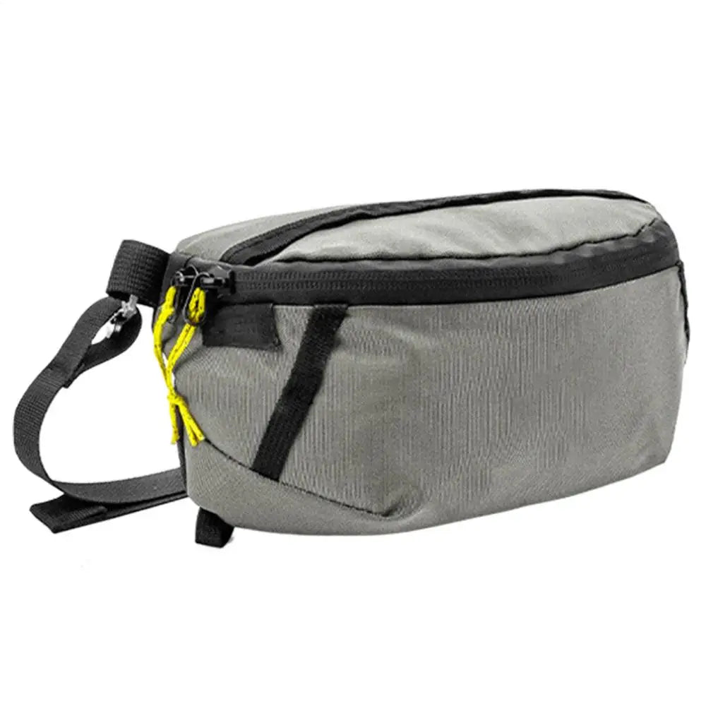 Gray waist bag with black strap and yellow zipper on a white background