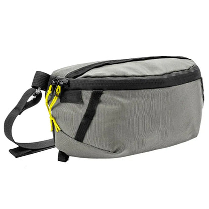 Gray waist bag with black strap and yellow zipper on a white background