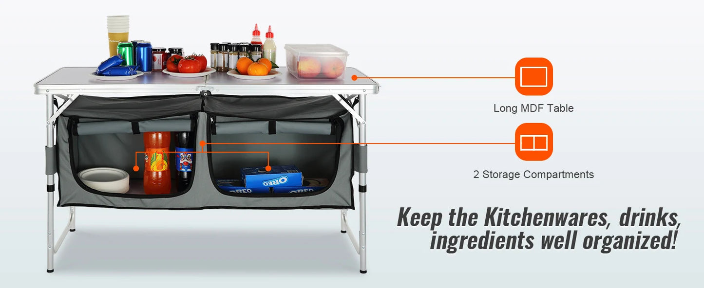 Camping kitchen setup with a table, storage compartments, and various items on a white background.