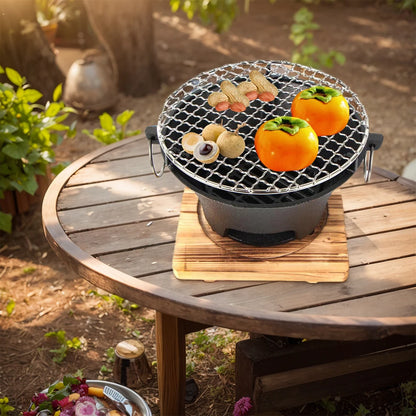 Portable grill with food on a wooden table outdoors