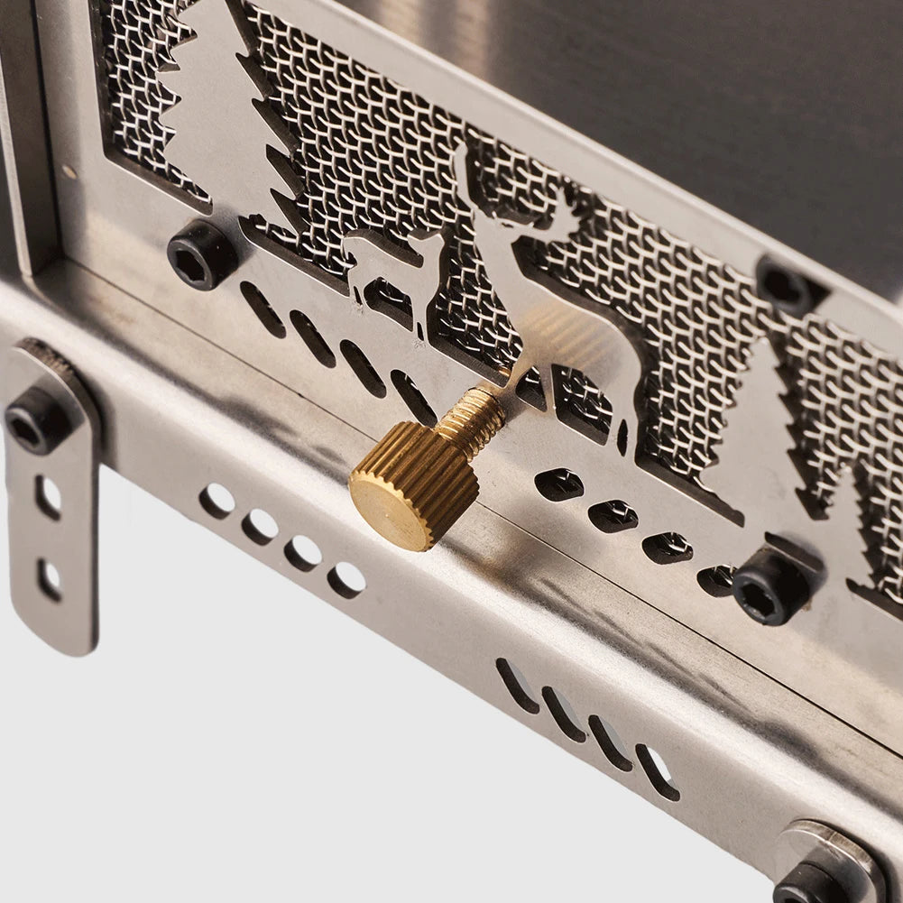 Metallic wood stove with a gold-colored knob on a light gray background