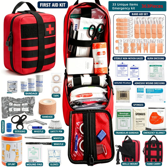 A red and black first aid kit shown open with its contents arranged around it on a white background. The kit includes bandage sets, sterile non-woven gauze, burn dressing, adhesive wound dressing, splint, wound pad, gloves, scissors, a whistle, safety pin, and other emergency care items.