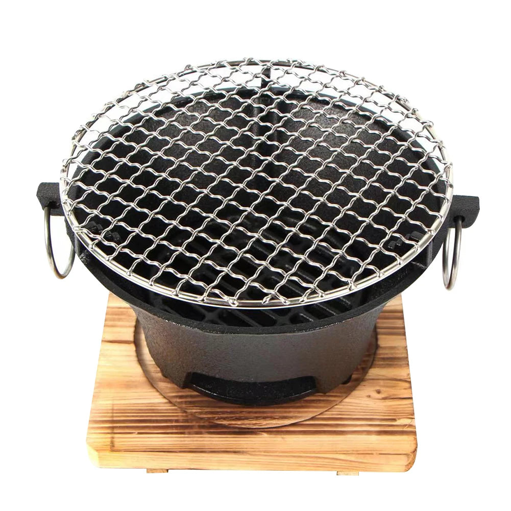 Black grill with metal mesh top on a wooden base against a white background
