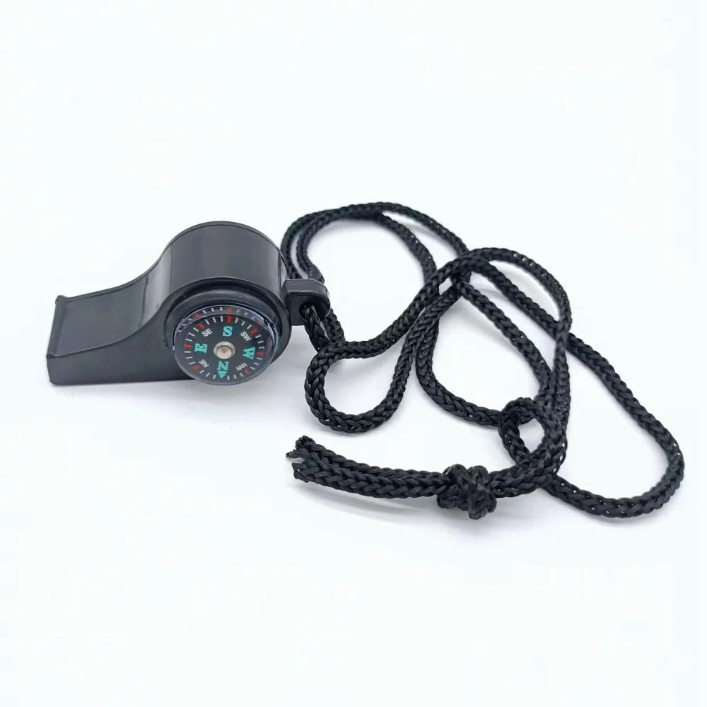 Black whistle with compass and rope on a white background