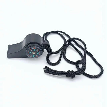 Black whistle with compass and rope on a white background