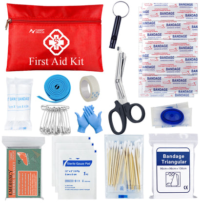 Collection of first aid supplies including a red bag, bandages, scissors, and other medical items on a white background.