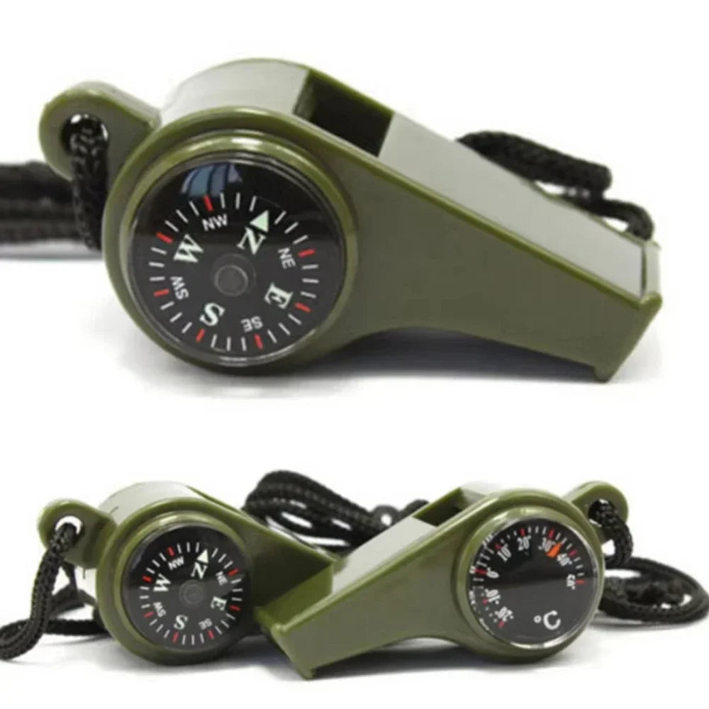 Green whistle with compass and thermometer on a white background