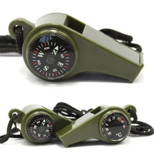 Green whistle with compass and thermometer on a white background