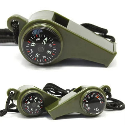 Green whistle with compass and thermometer on a white background