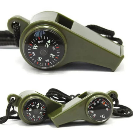 Green whistle with compass and thermometer on a white background