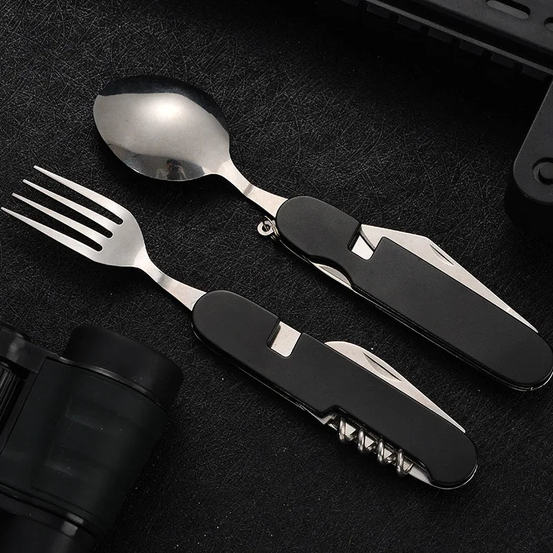 Set of silver cutlery with black handles on a dark surface