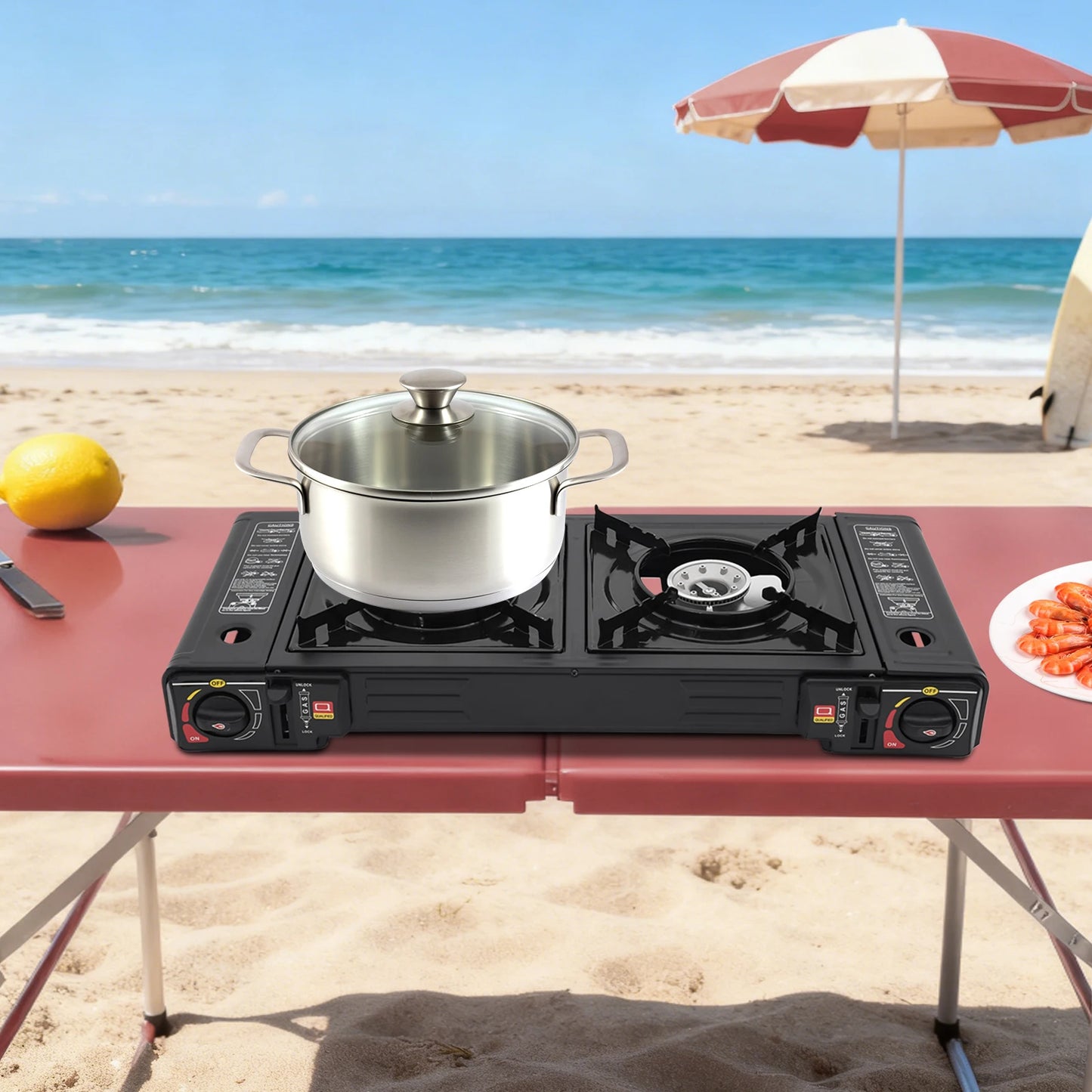 Portable gas stove with a pot on a beach table, lemon and plate of food nearby.