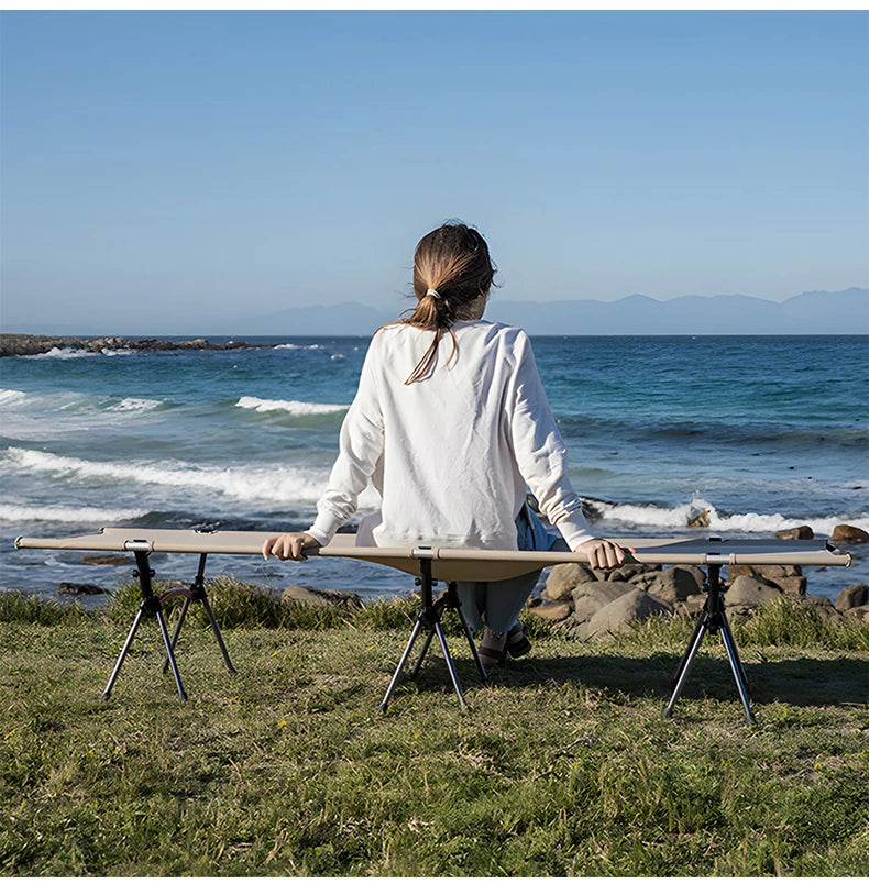 Person sitting at a portable table by the ocean