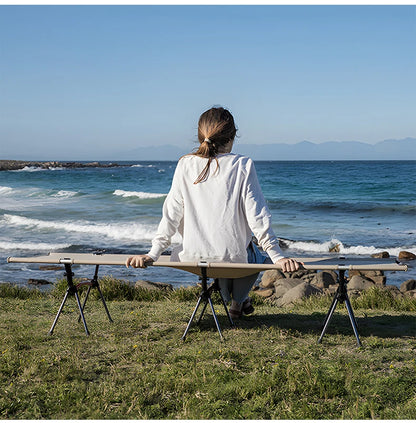 Person sitting at a portable table by the ocean