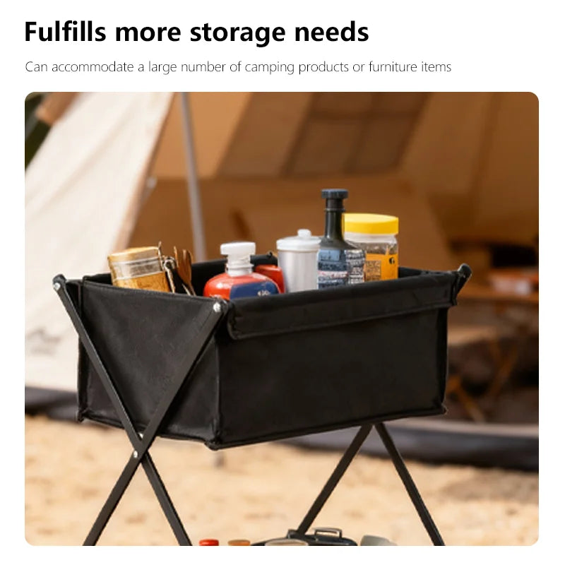 Black camping storage bin with supplies in front of a tent