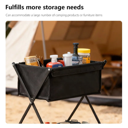 Black camping storage bin with supplies in front of a tent
