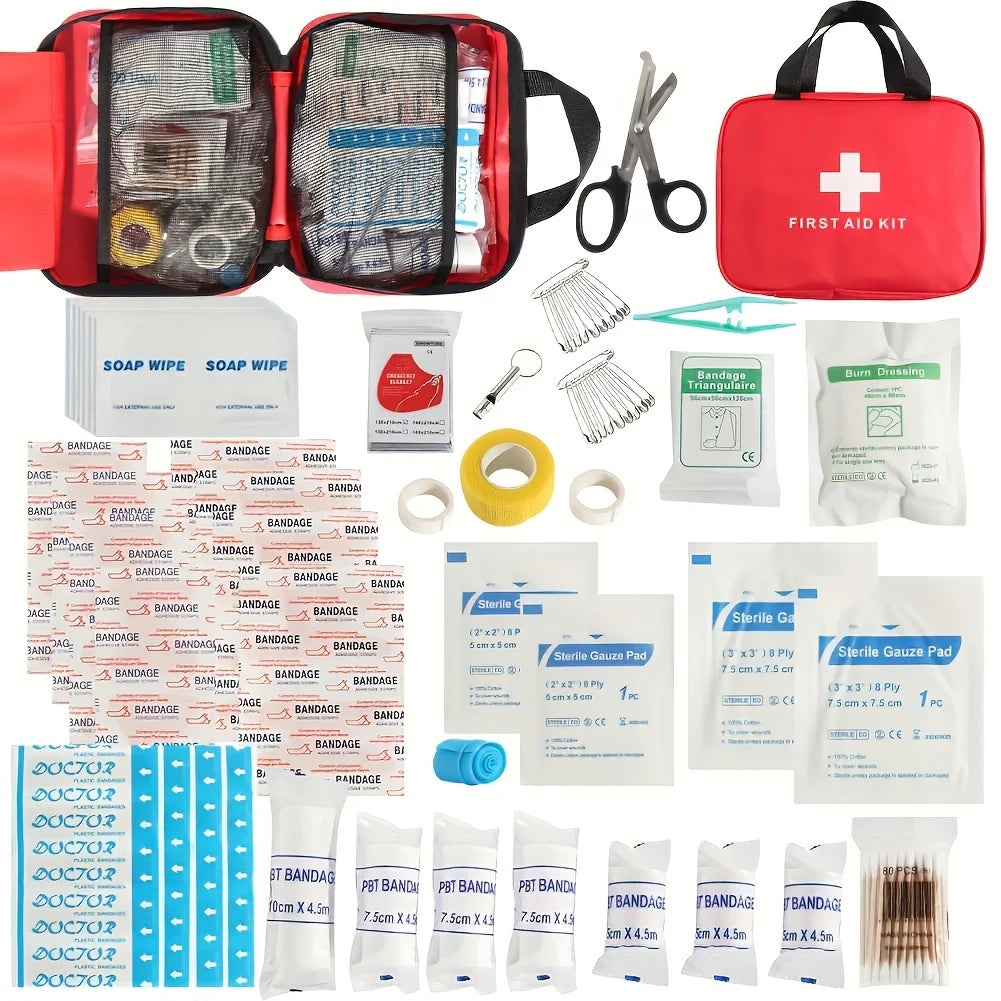 First aid kit with various supplies including bandages and scissors on a white background.