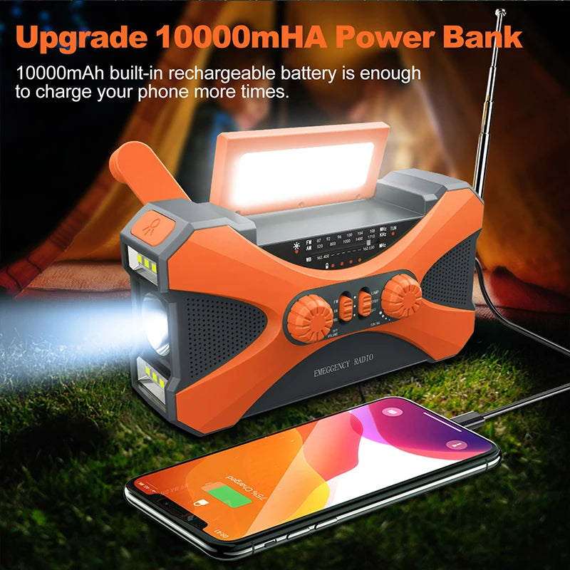 Orange power bank with flashlight and radio, charging a phone, on grass with fire in the background