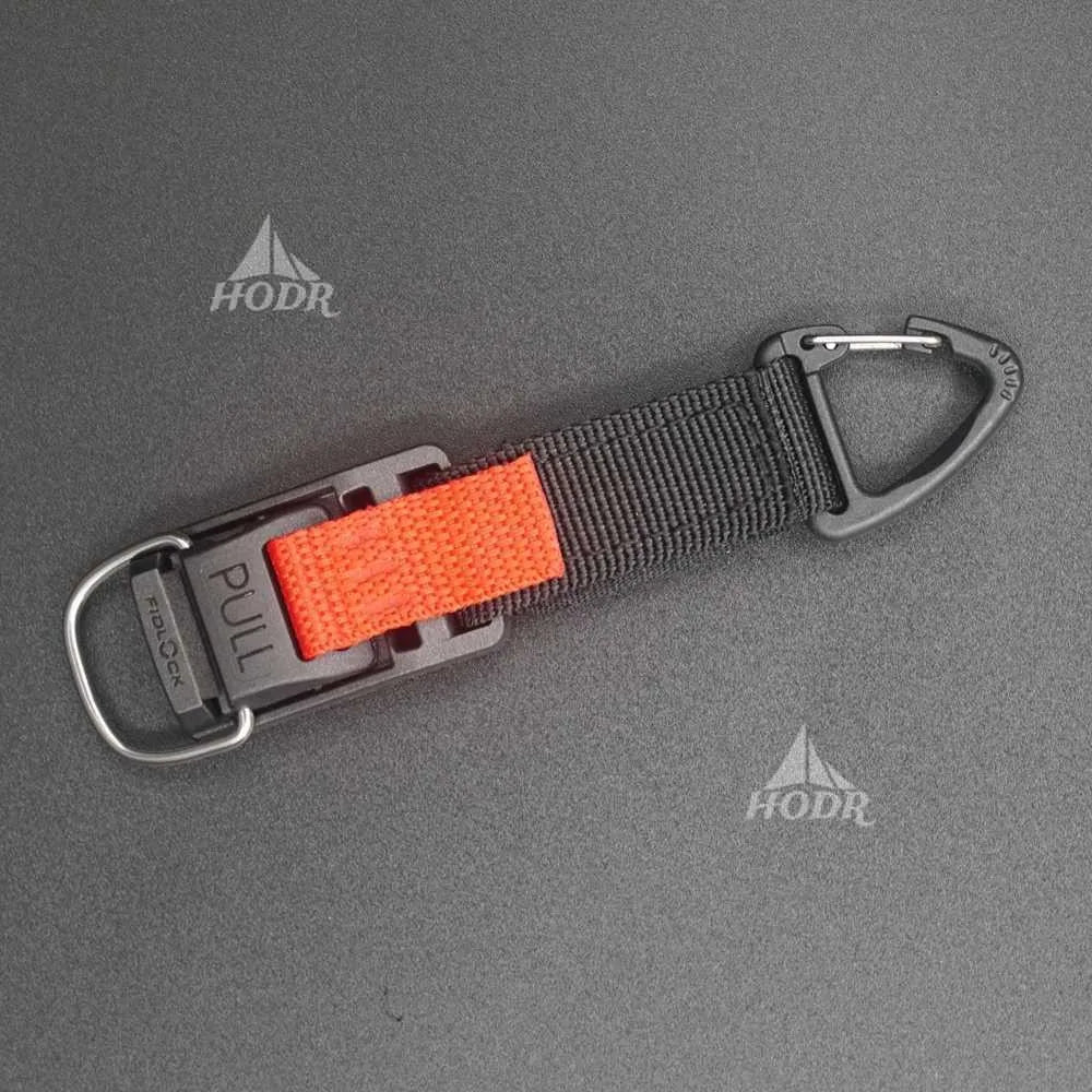 Keychain with orange pull tab and black carabiner on a gray background