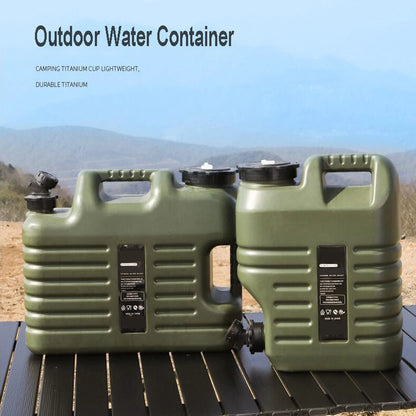 Two green outdoor water containers on a wooden surface with a mountainous background.