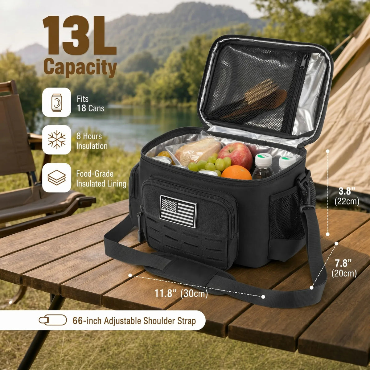 A black 13L insulated picnic cooler bag shown open on a wooden table outdoors, with a lake, trees, and mountains in the background. The cooler contains food and drinks, and the image includes dimension callouts and feature icons for capacity, 8-hour insulation, food-grade lining, and adjustable shoulder strap.
