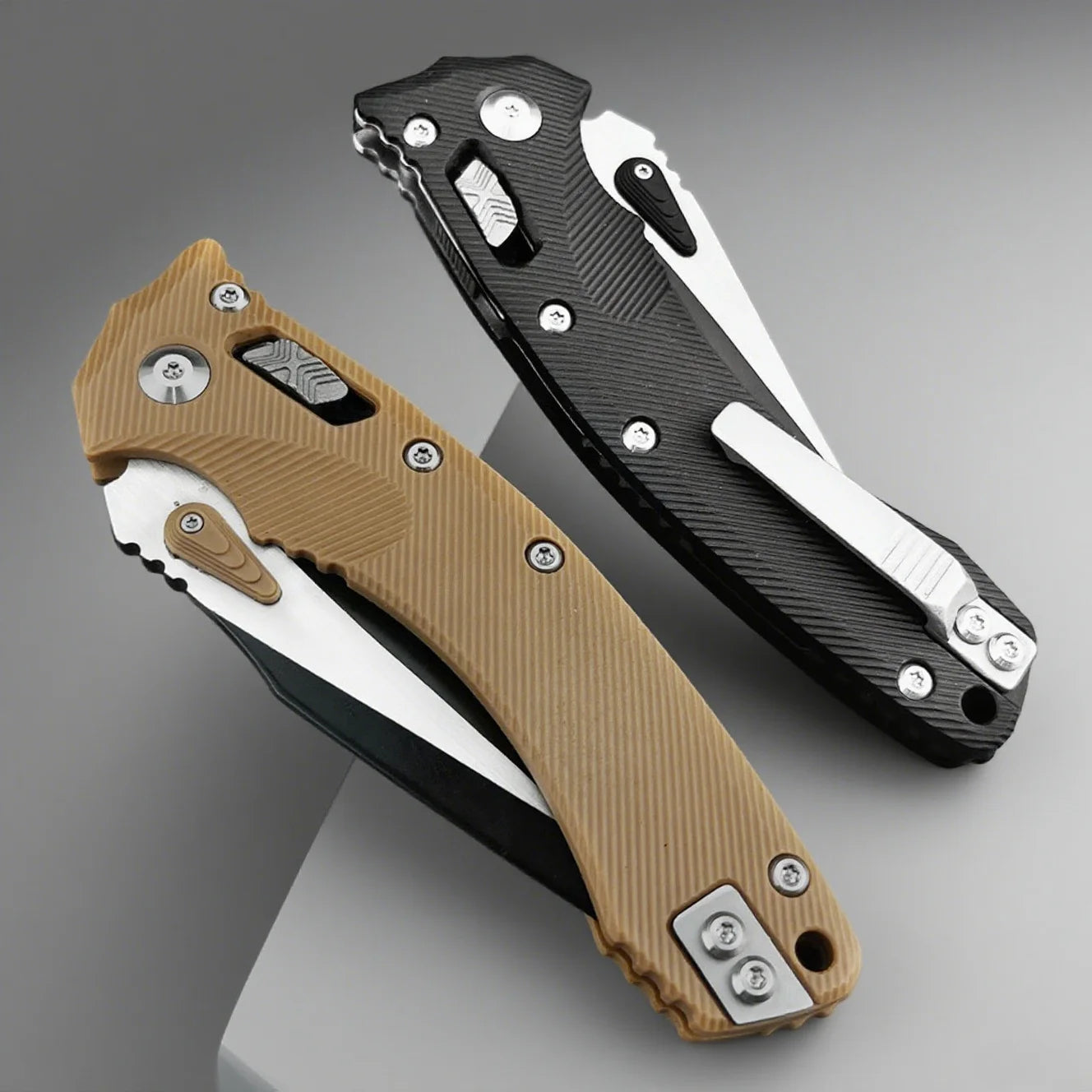Two folding knives, one brown and one black, on a gray background