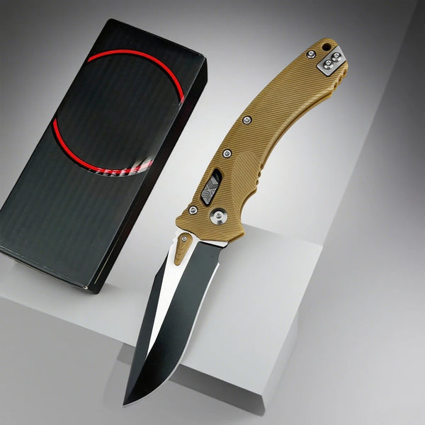 Folding knife with a g10 handle and black blade next to its black sheath on a gray background