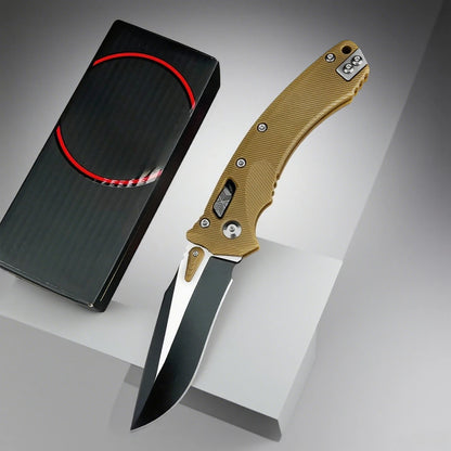 Folding knife with a g10 handle and black blade next to its black sheath on a gray background