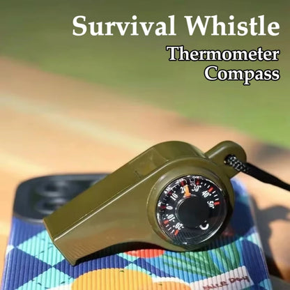 Survival whistle with thermometer and compass functions on a colorful mat.