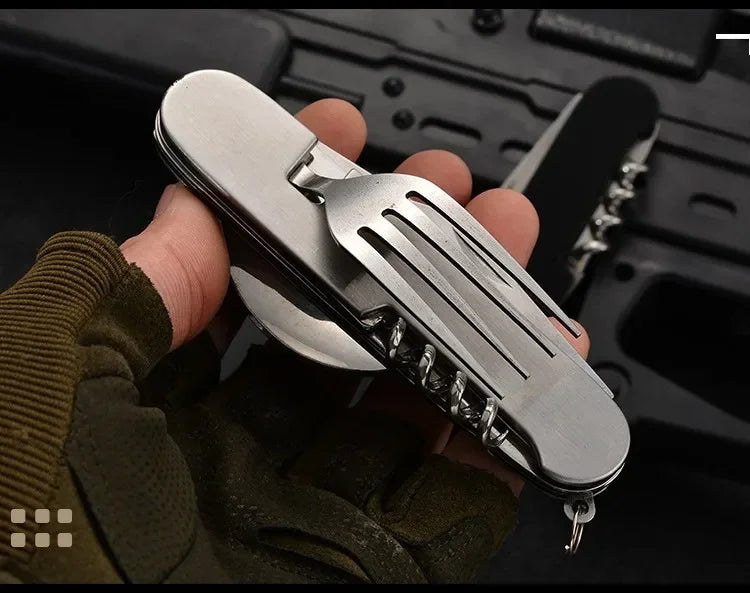 Hand holding a multi-tool with various functions against a blurred background