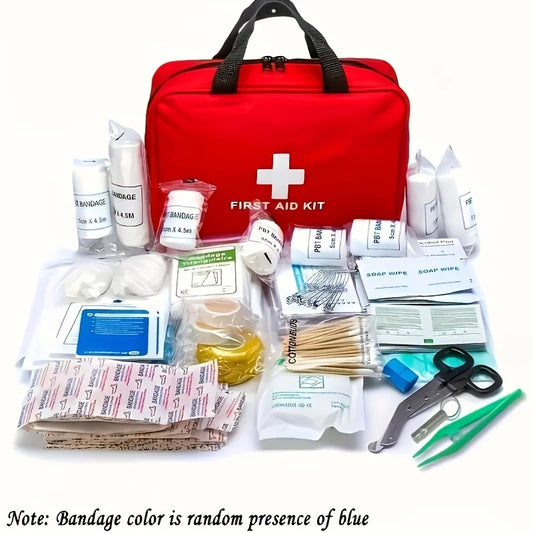 A red first aid kit bag with a white cross and 'FIRST AID KIT' printed on the front, displayed with assorted medical supplies arranged in front on a white background. The kit includes bandages, gauze, antiseptic wipes, tweezers, scissors, and other first aid items.