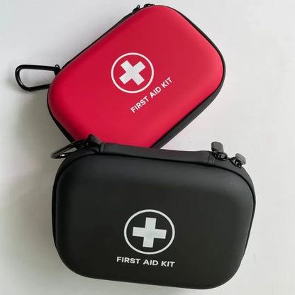 Red and black first aid kits with visible cross symbols on a light gray background