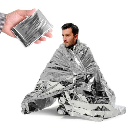 Person holding a silver mylar blanket and another person wrapped in it on a white background