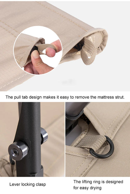 Close-up of a mattress strut with pull tab, lever locking clasp, and lifting ring on a beige background.